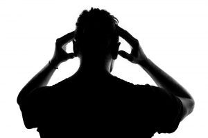 silhouette of man with headache